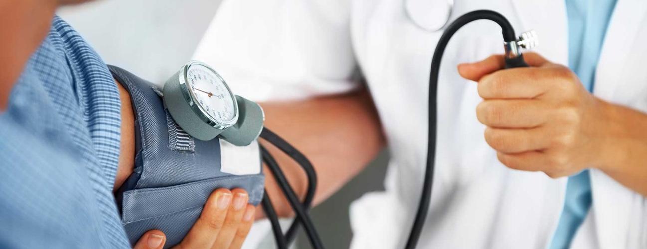Doctor taking men's blood pressure