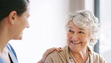 An older female patient talks with her doctor about mastectomy options.