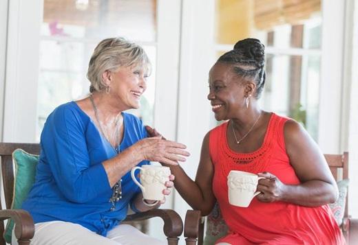two woman socializing  and drinking coffee