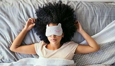 Woman sleeping with a sleep mask on