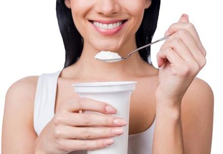 woman holding yogurt