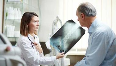 Doctor discussing back x-ray with patient