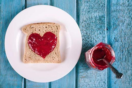 Jam spread on toast in the shape of a heart