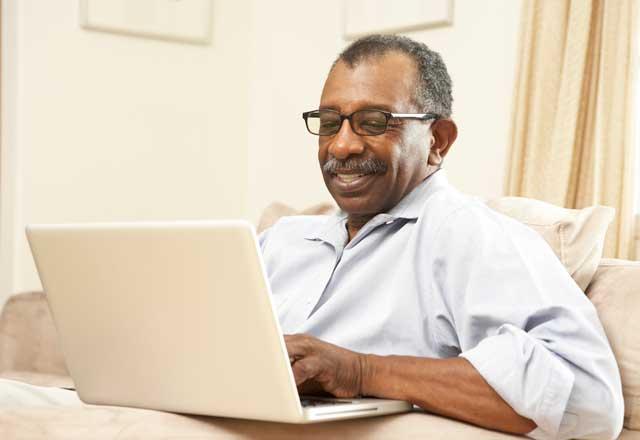 Middle age man typing on laptop